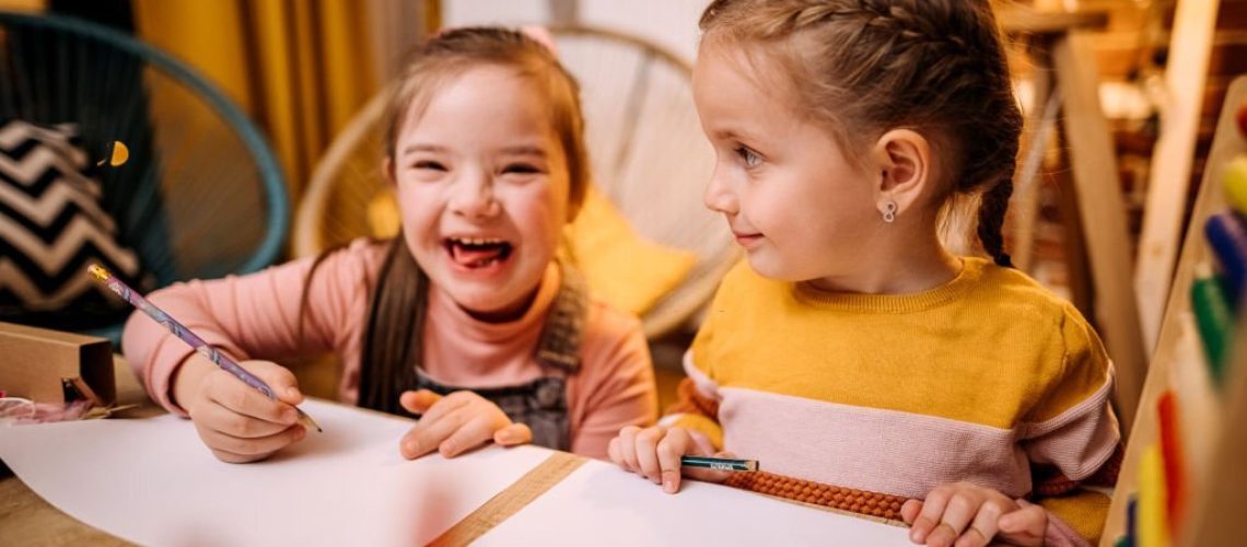 Shot of two sisters completing their homework togethe