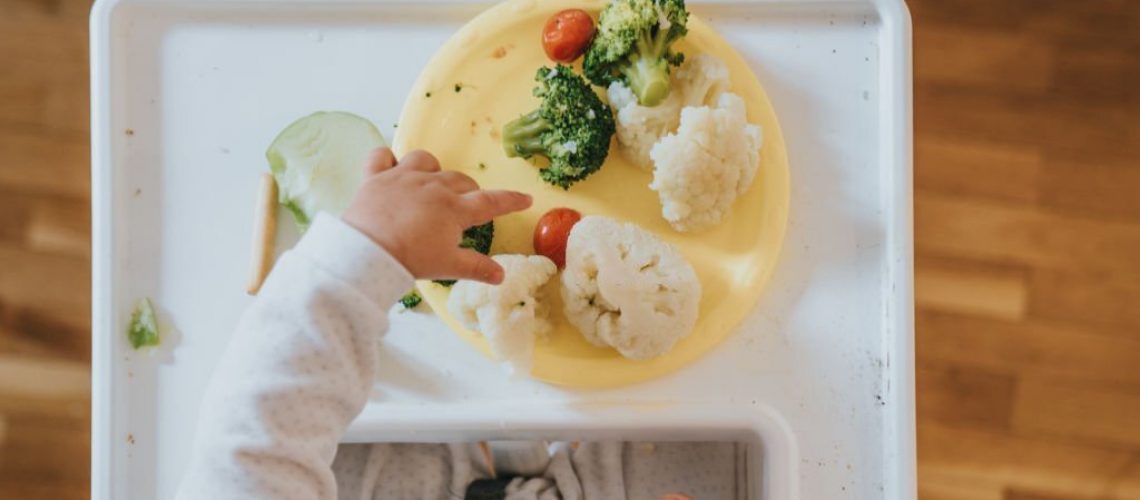 Baby eating vegetables