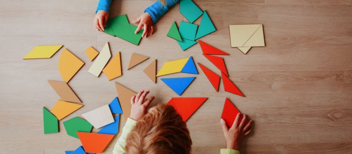 little boy and girl playing with puzzle, education concept