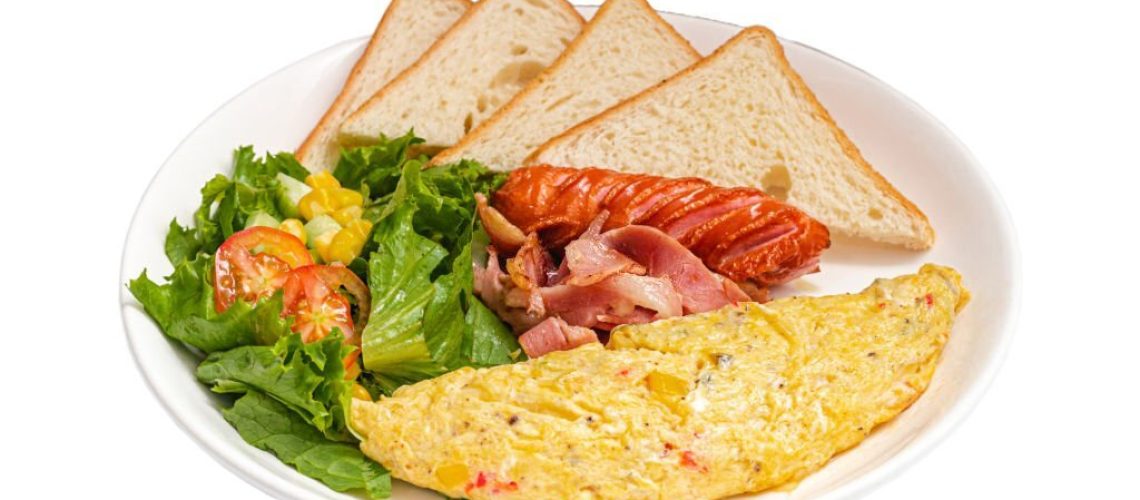 British Classic Breakfast with omelete, sausage, bacon, salad and sandwiches