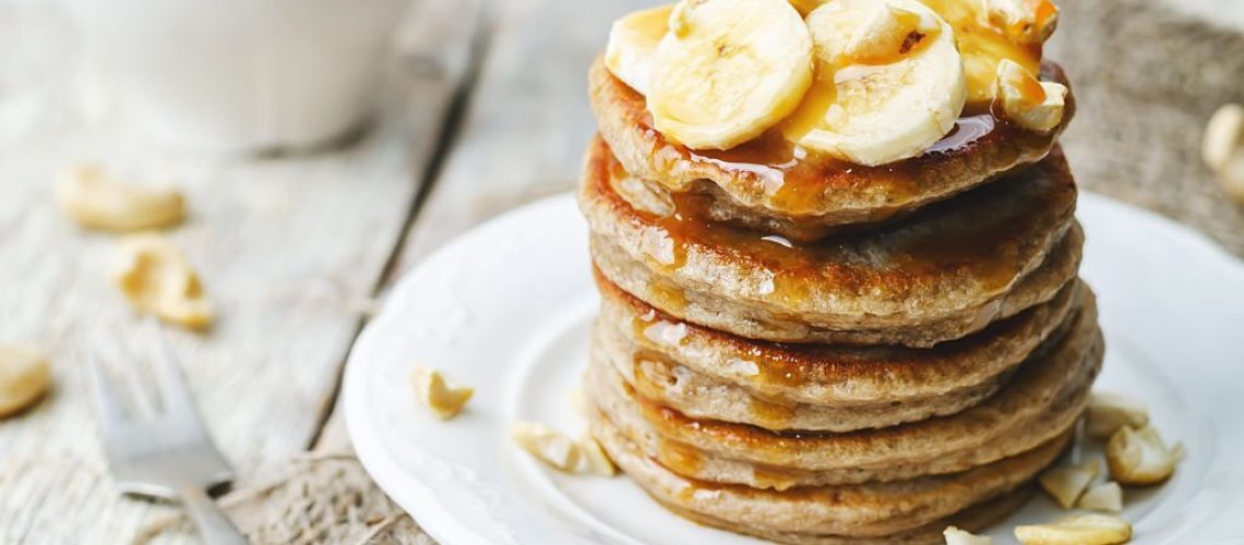 banana cashew pancakes with bananas and salted caramel sauce. the toning. selective focus