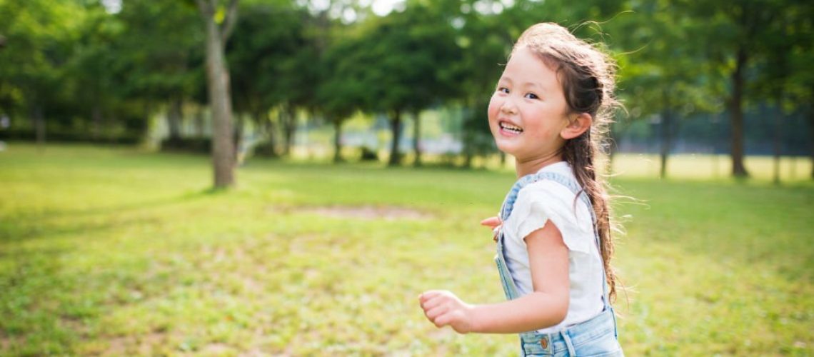 Little girl running while laughing